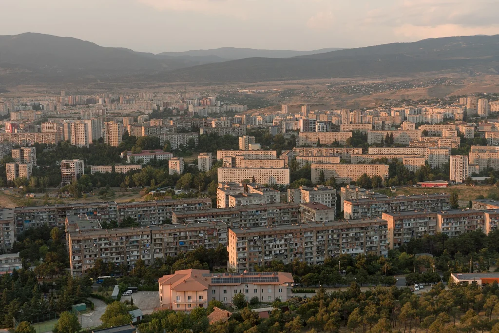 Panoramic view of Tbilisi's Soviet microdistrict apartment buildings from the Chronicle of Georgia monument.