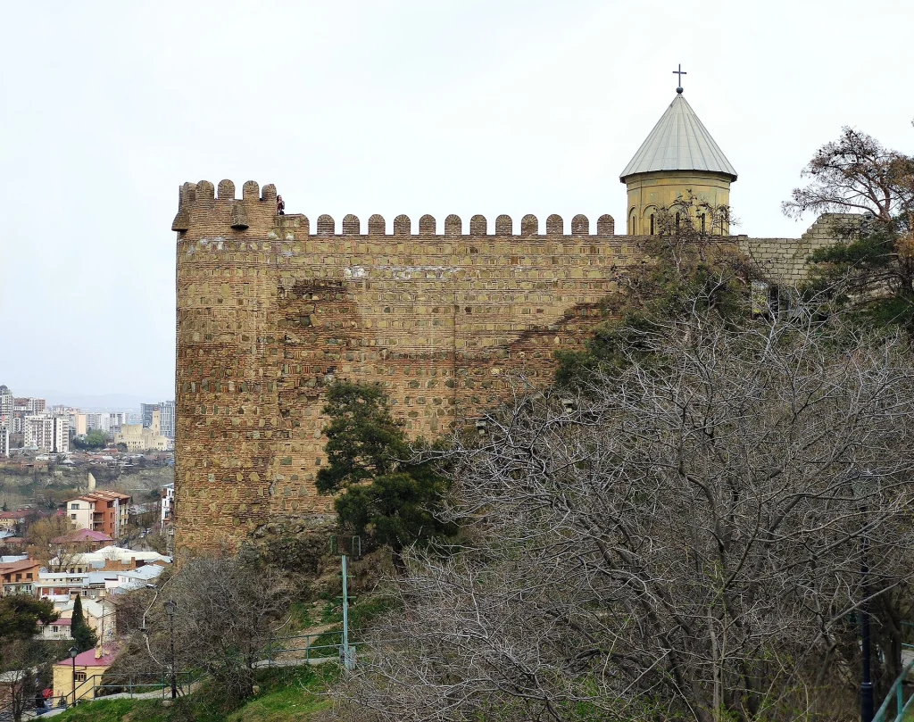 A wall of Narikala Fortress in Tbilisi, Georgia, with the city below.