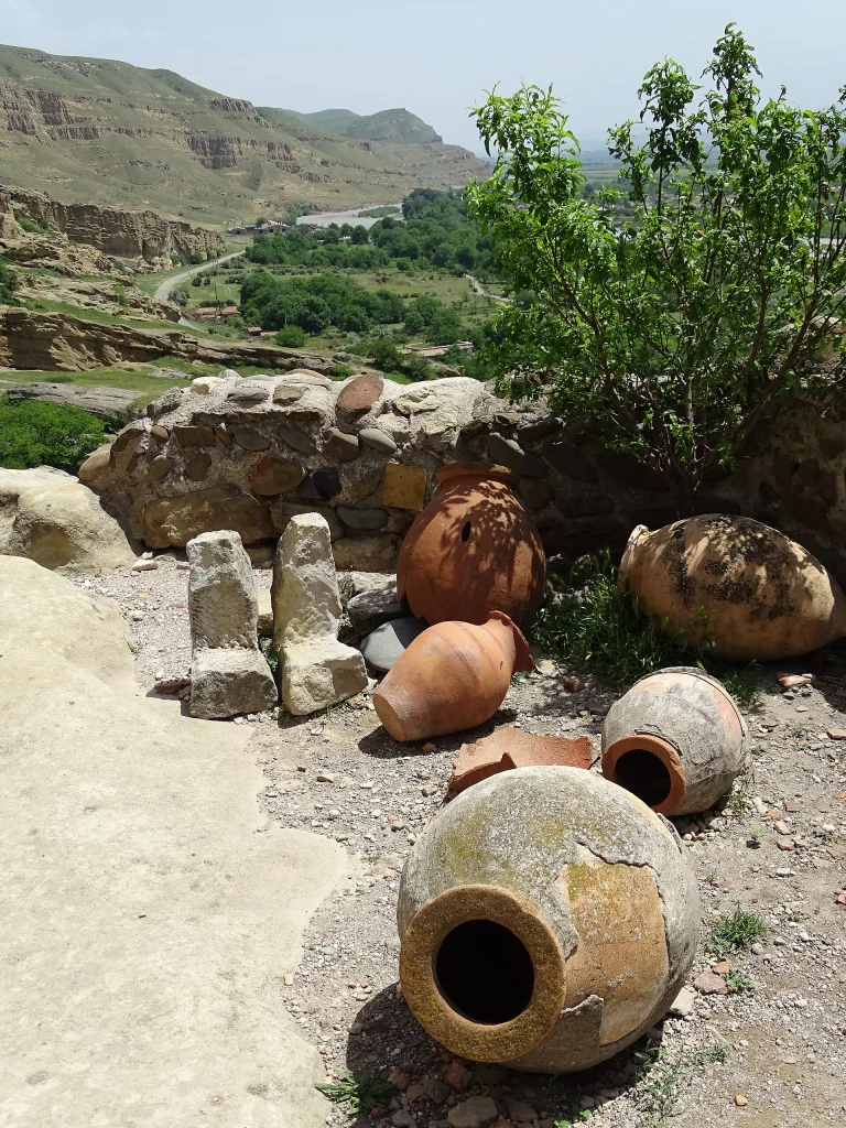 Ancient wine jars at Uplistsikhe cave city near Gori, a popular Georgian heritage site.