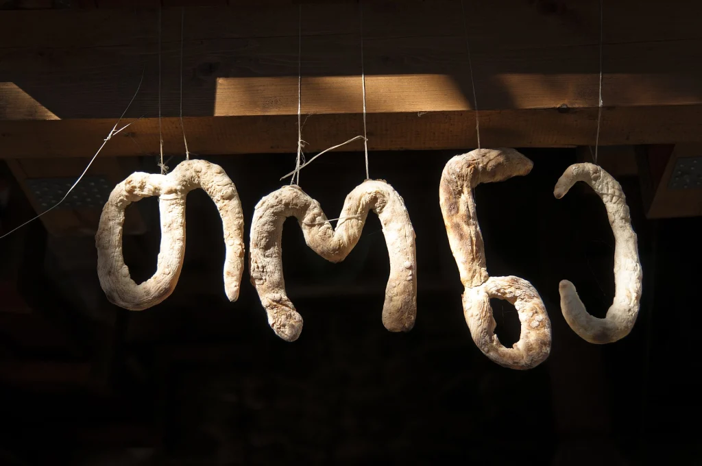 Looped shoti-style bread hangs ready for baking in a traditional tone oven.