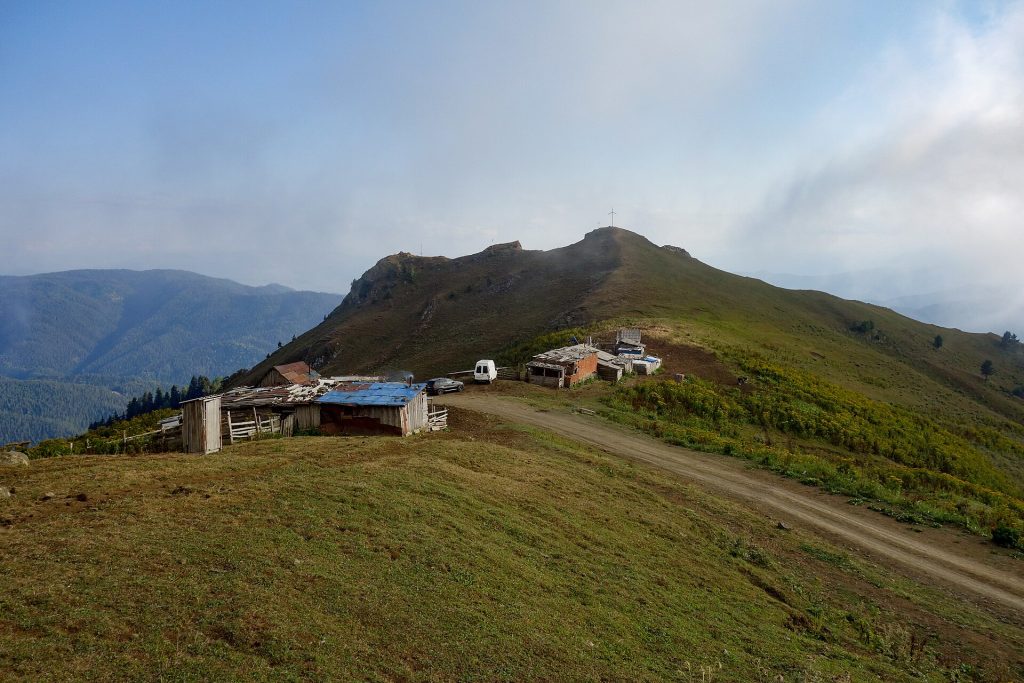 A shepherd's camp with huts and vehicles atop Zekari Pass, where the Zekaroba festival takes place.