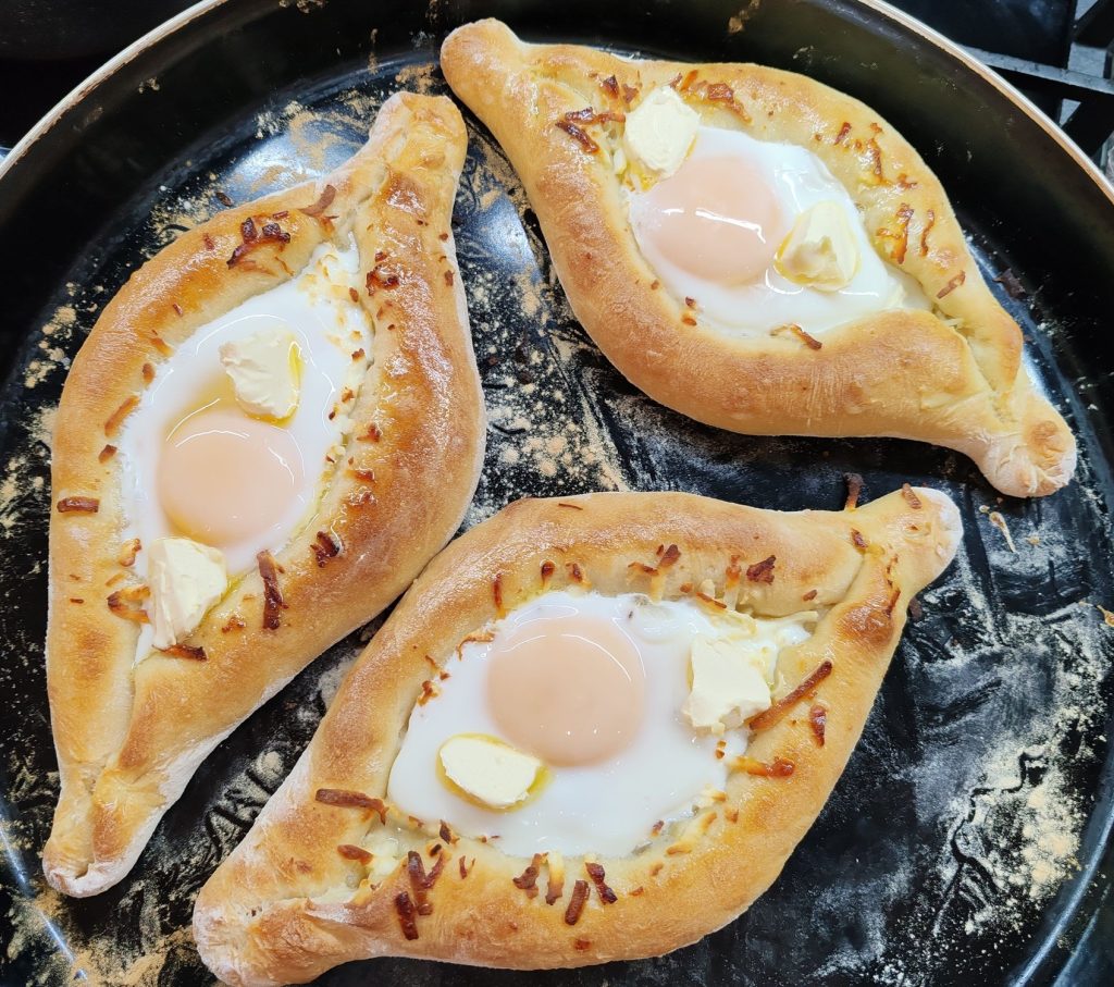 Adjarian khachapuri, the region's signature cheese-and-egg bread served at Gandagana stalls.