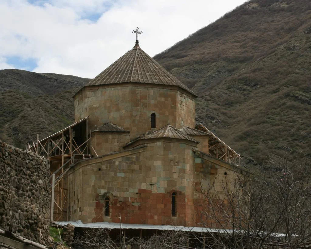 Exterior view of the medieval Ateni Sioni church set against steep hillsides.