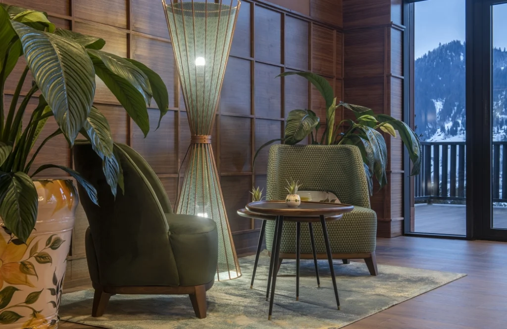 Bar — Cozy lounge seating by a window with a snowy mountain view outside.