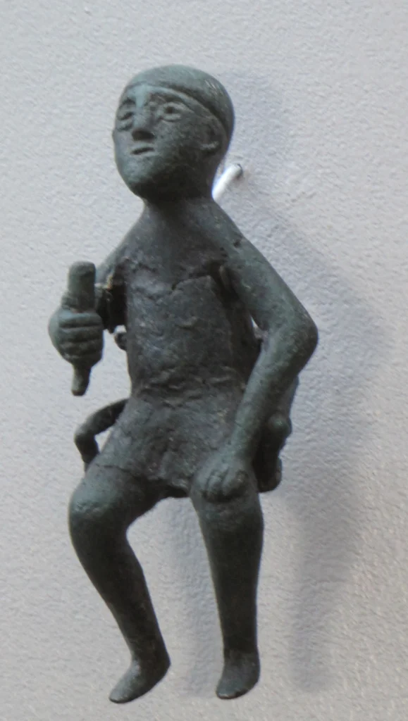 Ancient bronze figurine of a tamada holding a drinking vessel, Georgian National Museum.