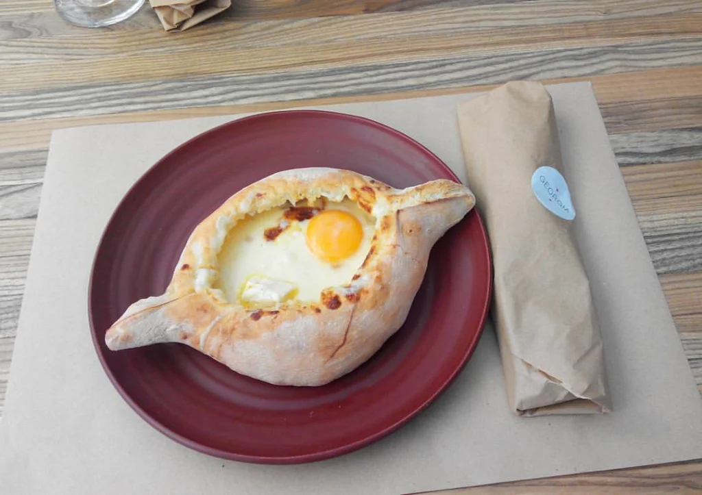 A classic Adjarian khachapuri with egg, the iconic Georgian dish visitors will encounter.
