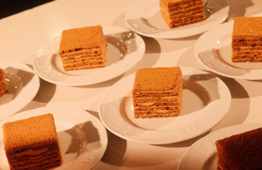 Daira Restuarant — Layered honey cake slices plated individually for dessert service.