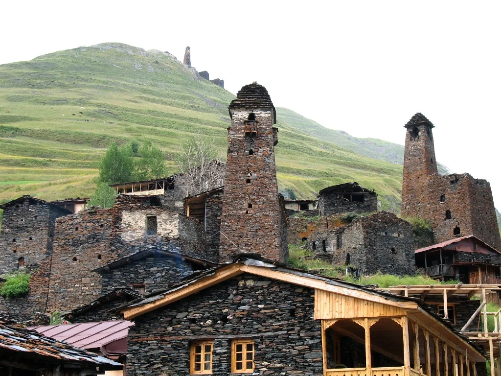 Medieval defensive towers and stone houses cluster on the hillside of Dartlo village.
