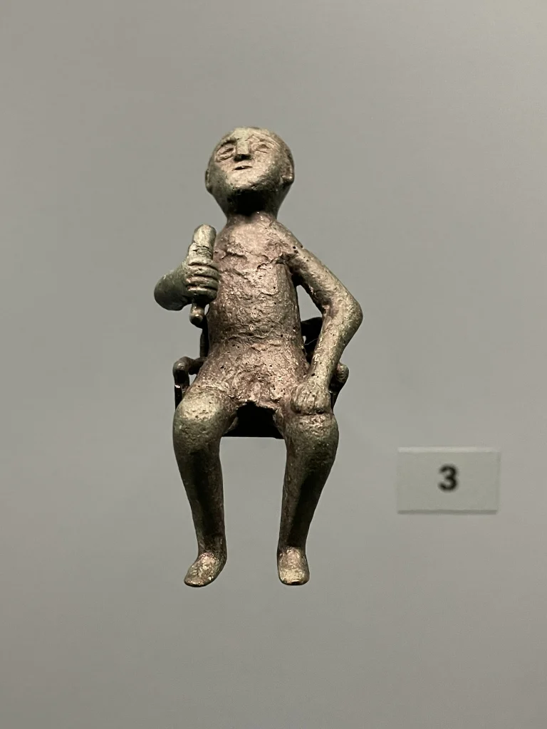 Ancient bronze tamada figurine from a Georgian history exhibition, depicting a toastmaster at a feast.