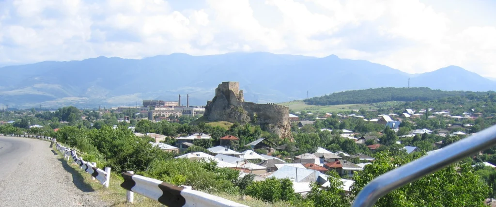 Panoramic view of Surami Fortress overlooking the town and surrounding mountain range.