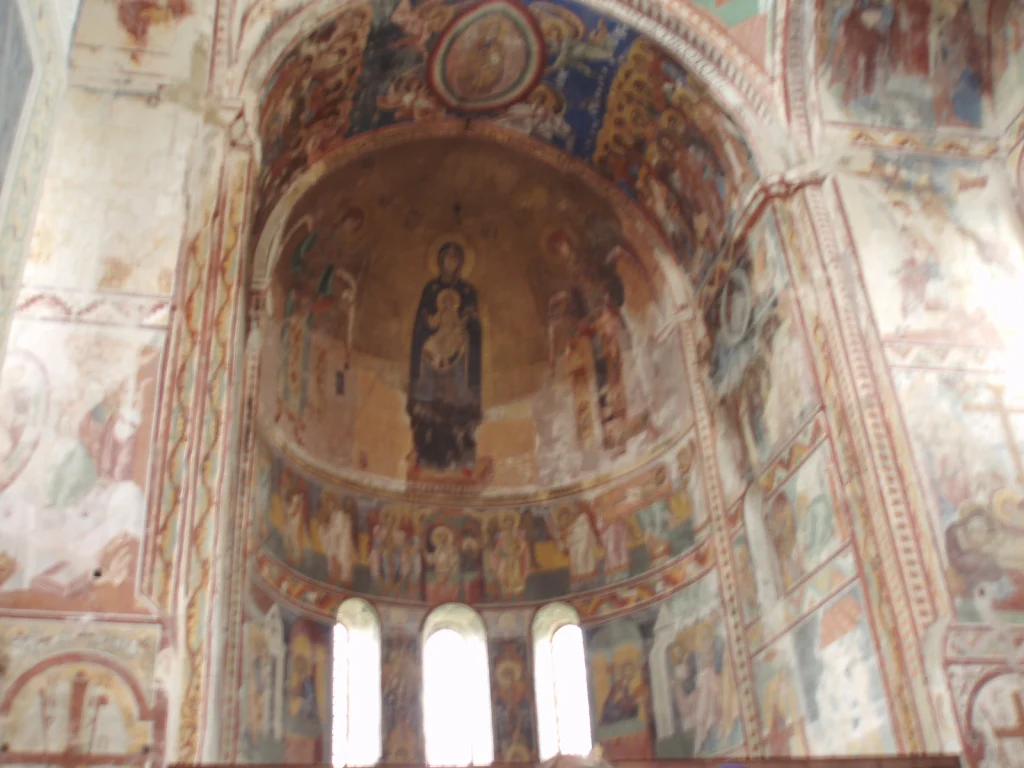Gelati Monastery's historic domed church complex set among green hills.
