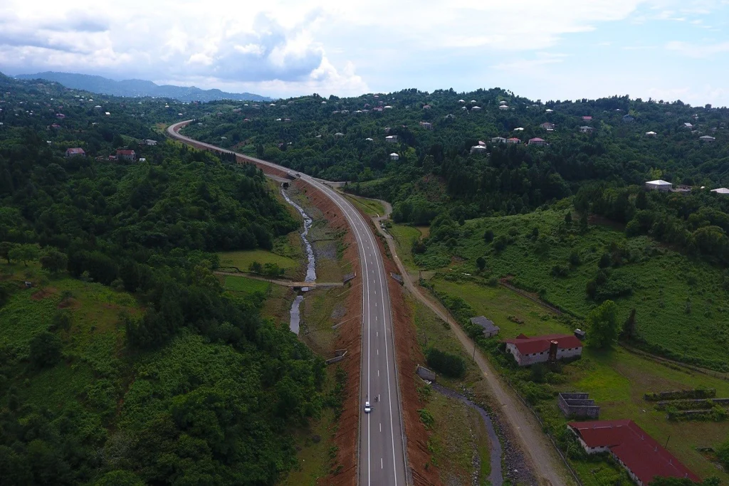 The Georgian S2 highway curving through forested hills near Chakvi, part of the Kutaisi–Batumi road.