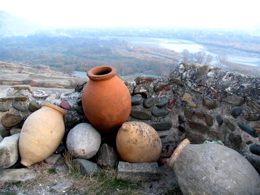 Large clay qvevri jars used for Georgian wine storage, typical of the Kakheti winemaking tradition.
