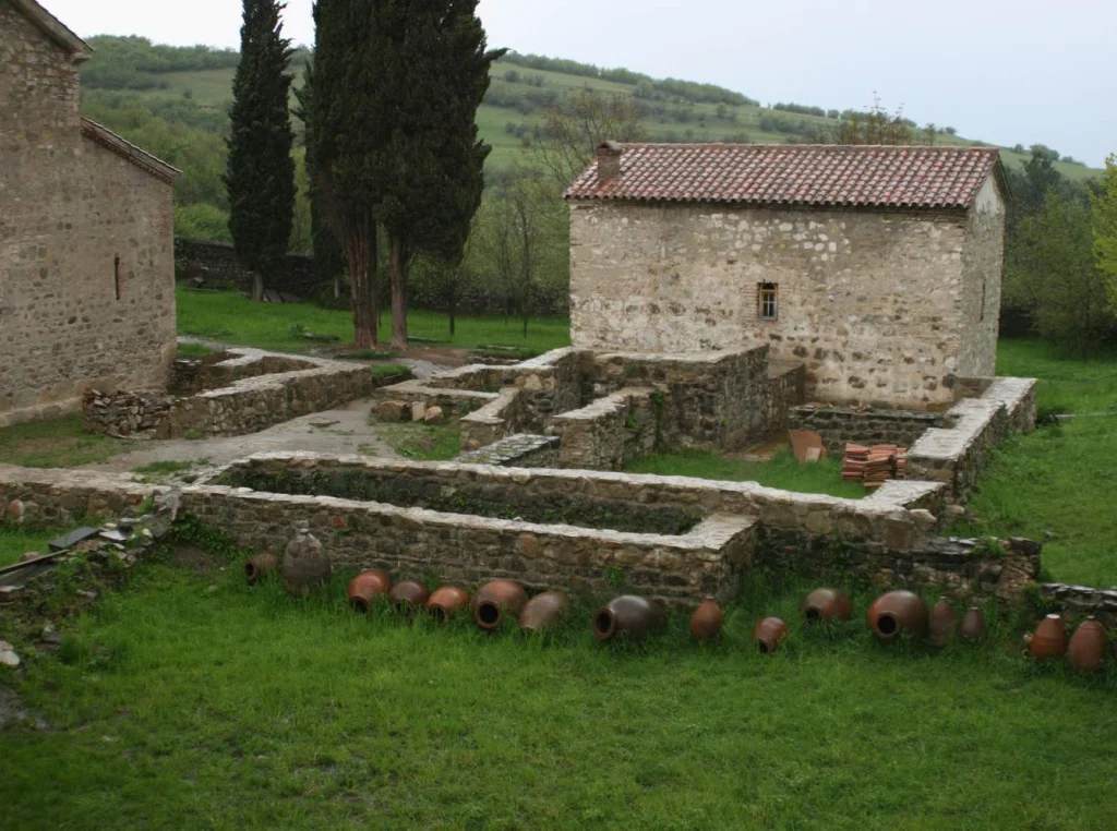 Ancient qvevri wine jars and cellar ruins at Ikalto Monastery, a centre of early Georgian winemaking.
