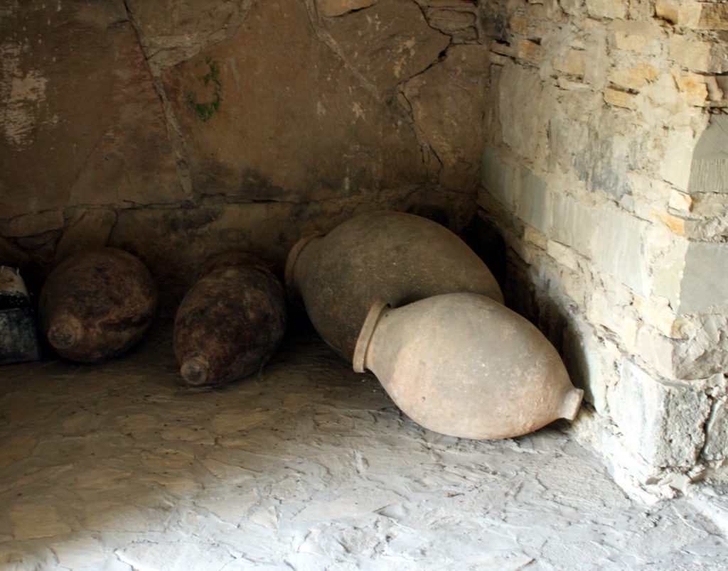 Traditional wine jars at a Georgian church, reflecting the rural setting of Gardabani's Trinity festivities.