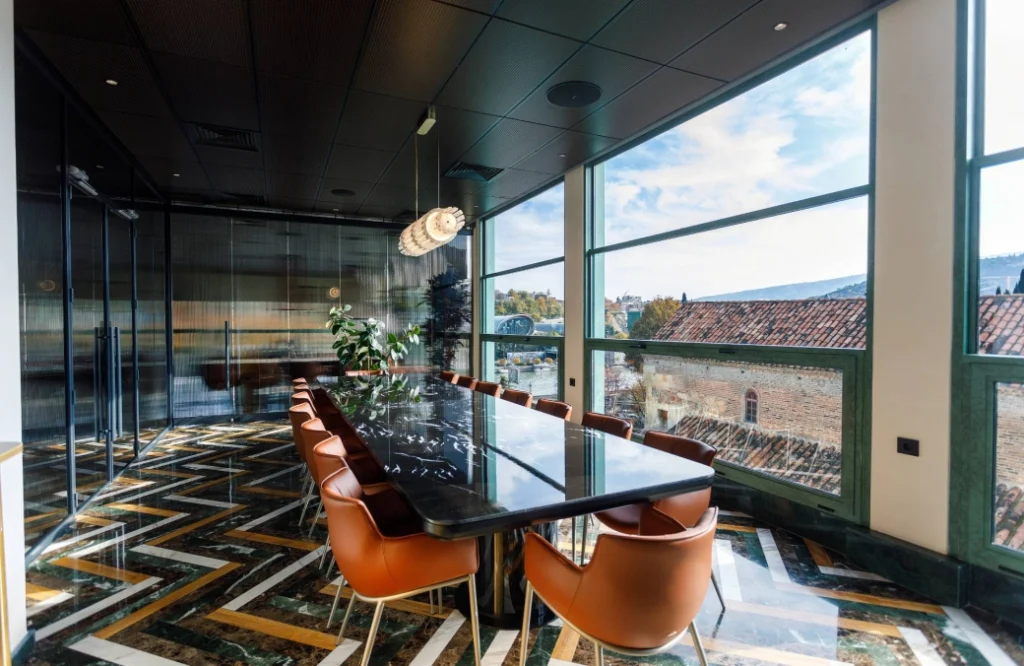 MOZAIKO — Glass-walled dining space with panoramic rooftop views of the surrounding city skyline.