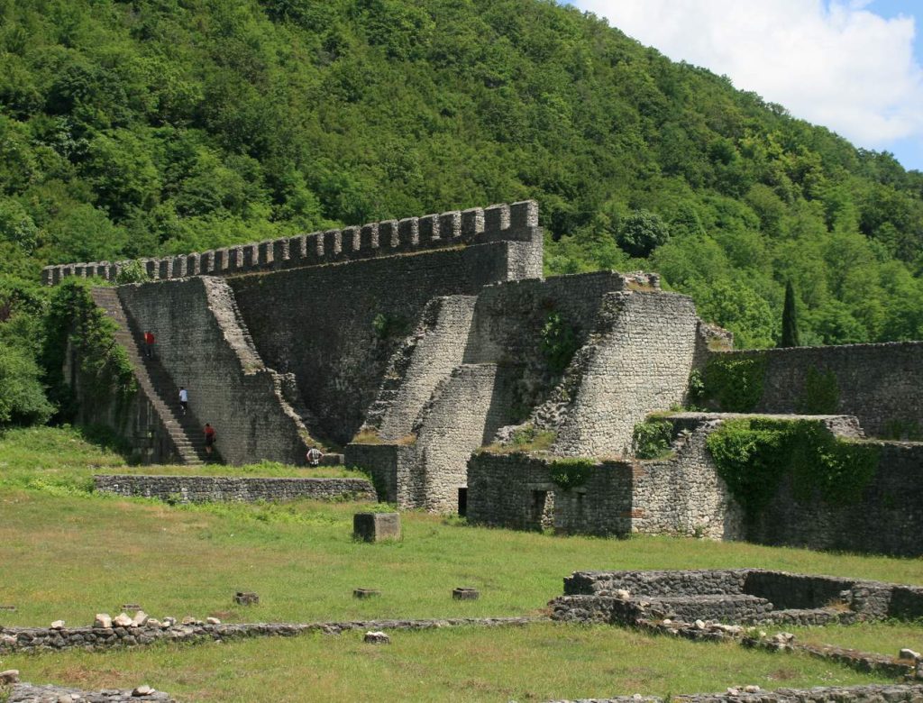 Visitors explore the massive stepped ramparts of the Archaeopolis fortress.