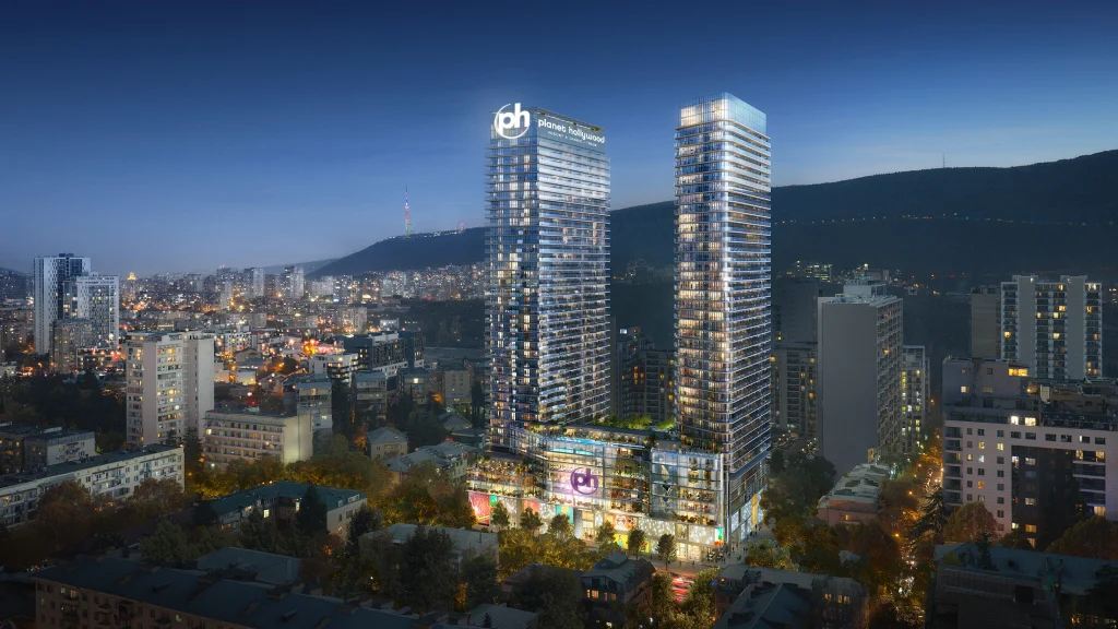 Planet Hollywood Hotel & Casino Tbilisi — Twin towers of Planet Hollywood illuminated at dusk against the Tbilisi skyline.
