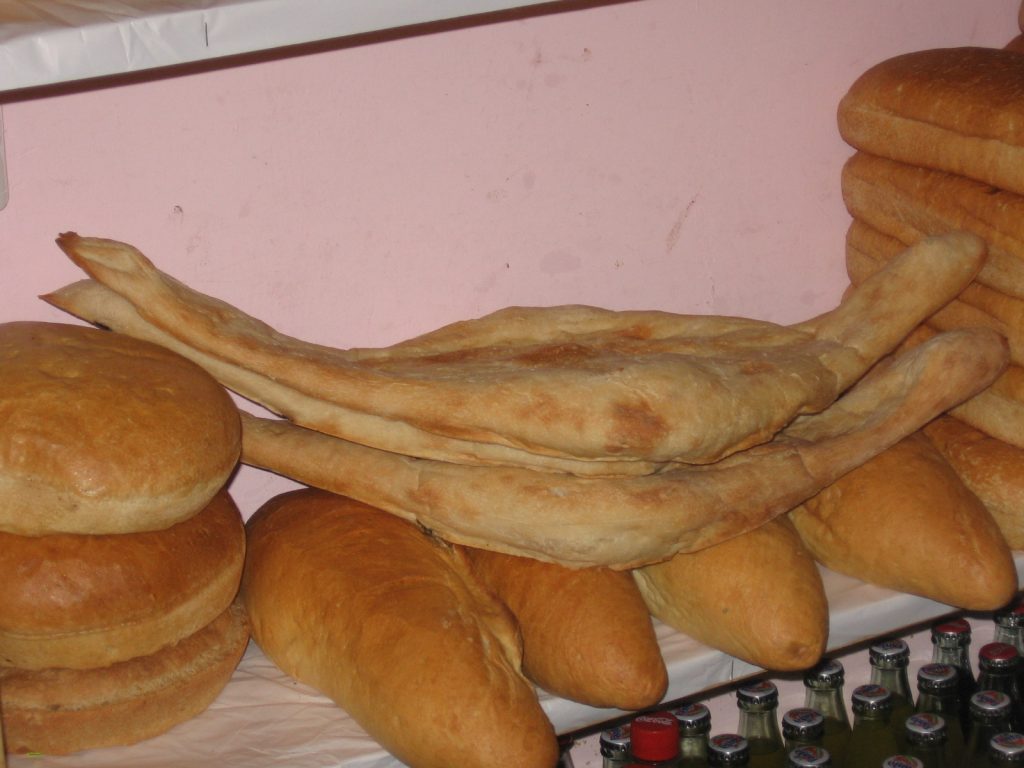 A stack of freshly baked shoti loaves, the iconic boat-shaped Georgian bread.
