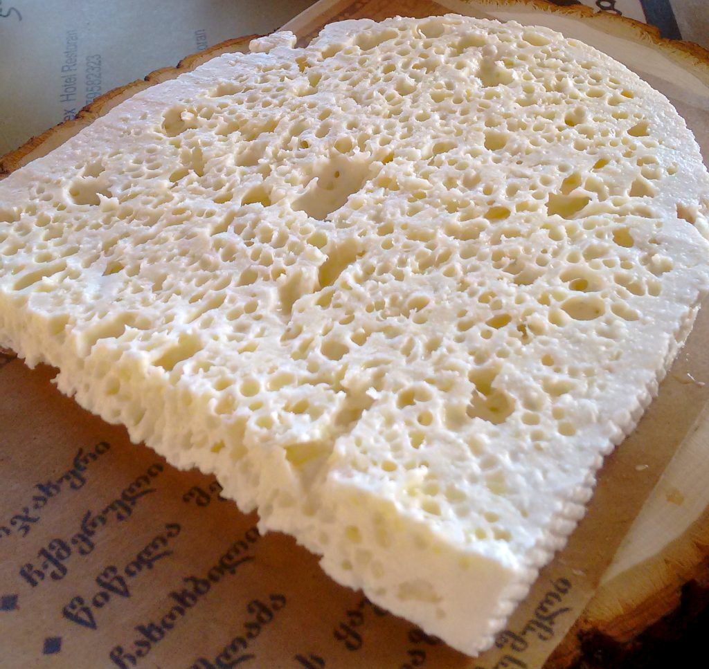 A slice of sulguni, one of over 60 traditional Georgian cheese varieties showcased at the festival.