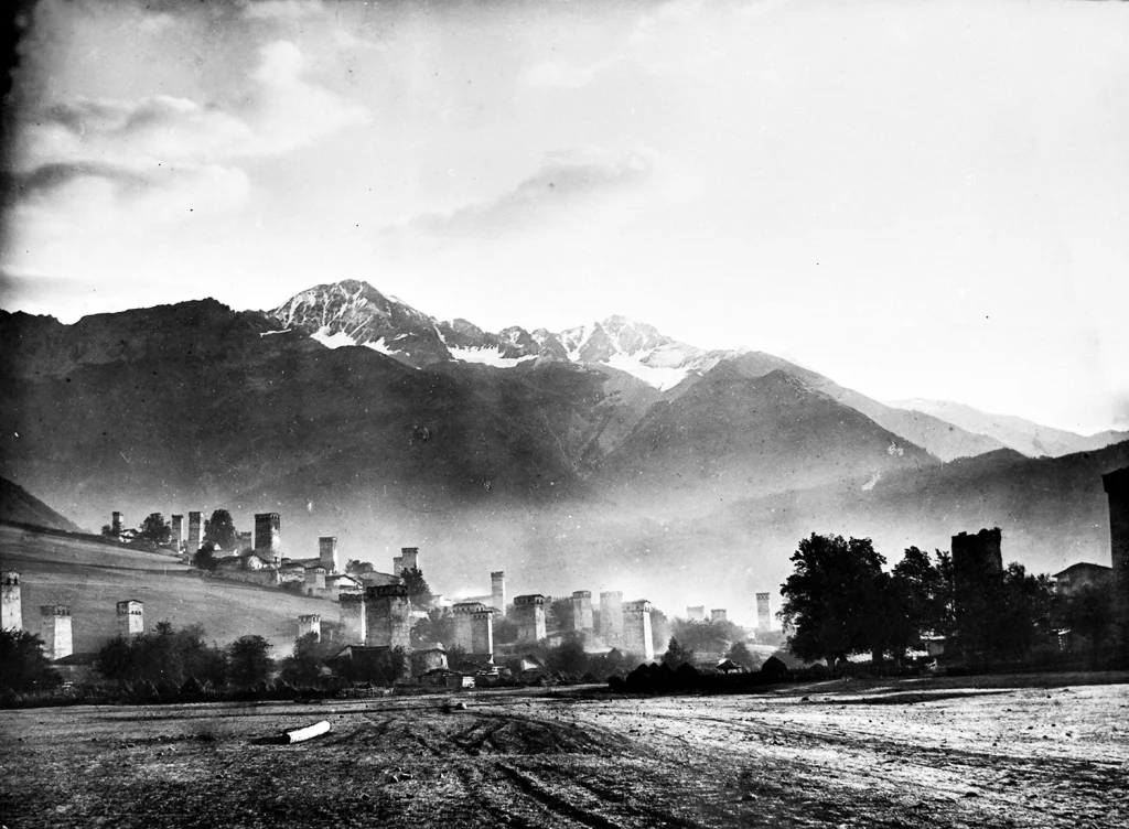 Historic view of Mestia's ancient defensive towers beneath the snow-capped Caucasus range.