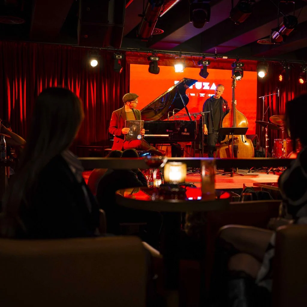 Tatuza Jazz Club — Musicians performing on stage with pianist and bassist during a live set.