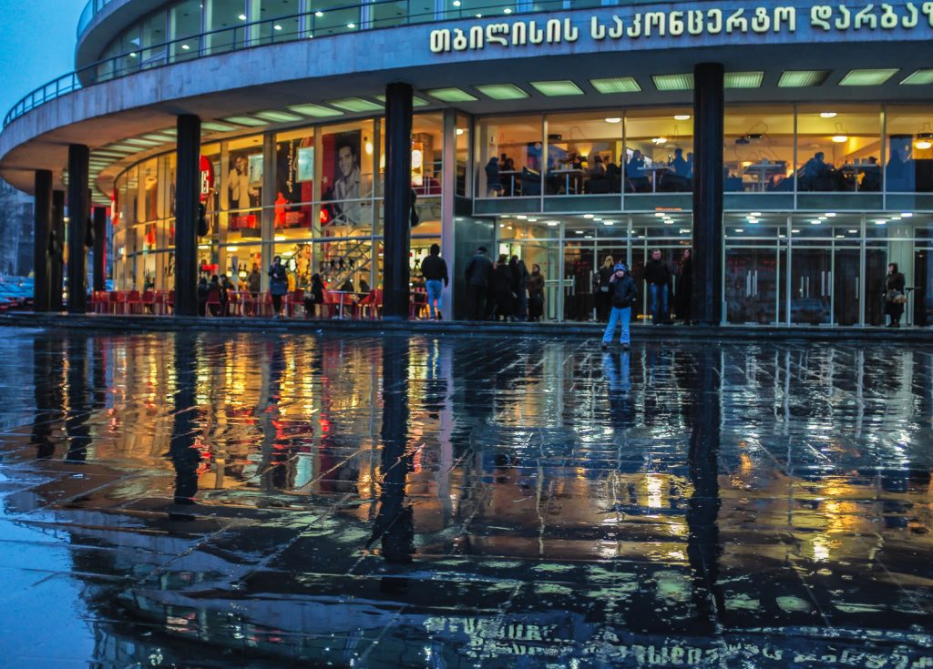 Concertgoers gather outside the Tbilisi concert hall in the evening ahead of a performance.