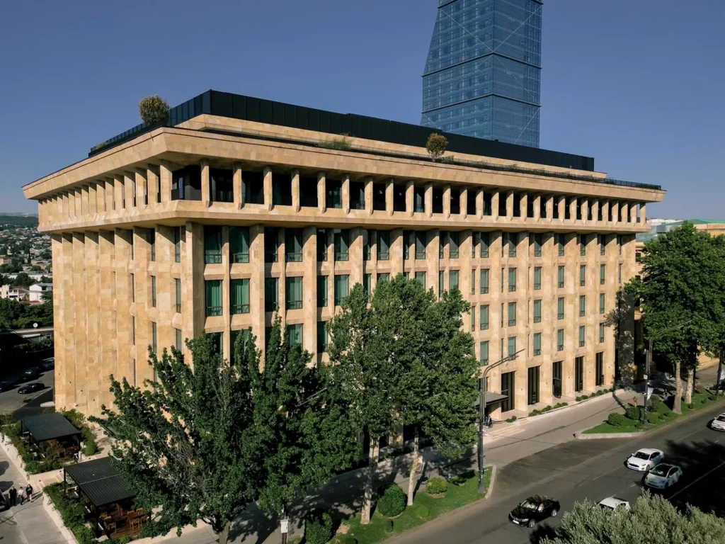 Telegraph Hotel — Daytime aerial view of the hotel's distinctive colonnaded stone facade and rooftop.