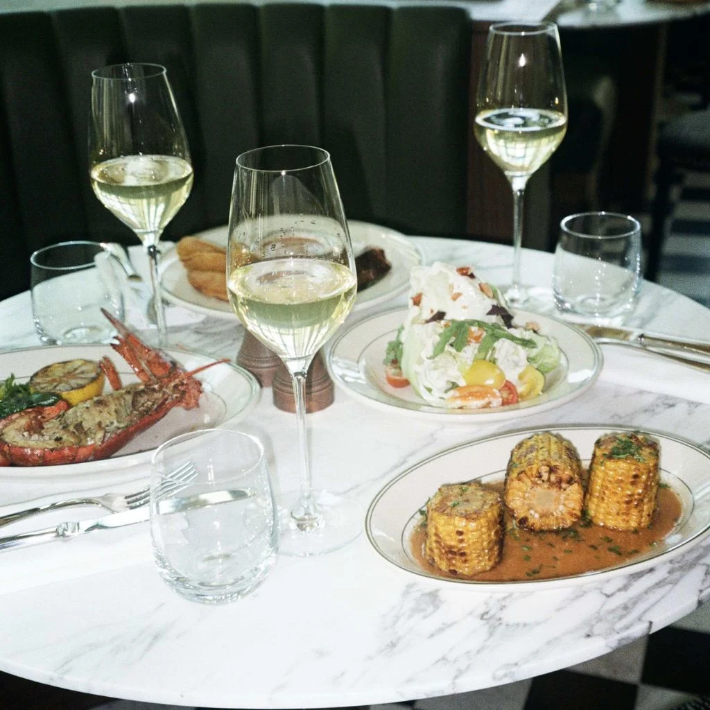 The Grill — Table set with seafood, salad, and wine glasses at the restaurant.