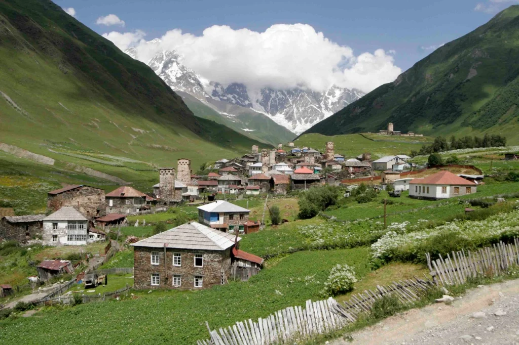 Ushguli village beneath Mount Shkhara exemplifies the rugged Caucasus landscape straddling the Europe-Asia divide.